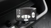 Vehicle climate control module mounted in a car dash with a digital display showing 19.4°C and buttons labeled SET, ON, OFF, and +/-; Carrier logo visible.