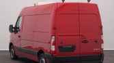 Rear view of a red Renault Master cargo van with closed rear doors and black bumper, photographed in a studio setting.