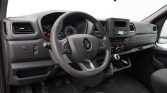 Interior of a Renault van showing the steering wheel, instrument cluster, center console with radio, and manual gear shifter.
