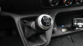 Close-up of a six-speed manual gear shift knob showing the R-1-3-5 / 2-4-6 shift pattern in a car interior