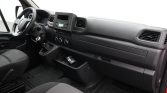 Driver's side interior of a van showing steering wheel, gear shifter, and dashboard with central infotainment display and climate controls