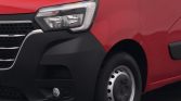 Front-left view of a red van showing the headlight, black bumper, and front wheel hubcap.