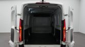 Rear of a white cargo van with double doors open, showing an empty, dark cargo area ready for loading.