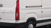 White Maxus Deliver 9 van rear side with vertical taillight, rear door seam, and wheel visible