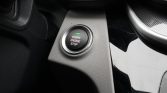 Start/Stop engine push button on car center console with green indicator