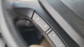 Steering wheel with audio control buttons: up/down arrows to skip tracks and a plus/minus for volume.
