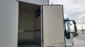 White cargo truck with rear access door open, showing empty loading area and metal wall lining inside.