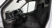 Interior of a modern van: driver’s seat, two front passenger seats, and the dashboard with steering wheel visible beside the door.”] ,