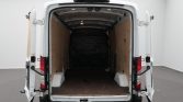 White cargo van with rear doors open, empty plywood-lined cargo area ready for loading
