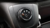 Circular gear selector dial on a car center console showing P R N D and L, with an orange indicator near P