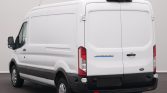 Rear view of a white Ford Transit cargo van with double rear doors and dark bumper in a neutral studio setting