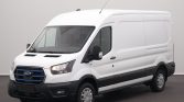 White Ford cargo van photographed from a three-quarter front angle, showing its large cargo area and black bumper trim
