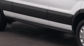 Side view of a white cargo van with black protective side molding and a lower running board, showing the front passenger-side wheel partially visible.