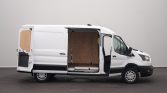 White cargo van with its side door open, revealing an empty plywood-lined cargo area inside a studio setting
