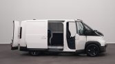 White cargo van with both side and rear doors open, showing empty cargo area inside.