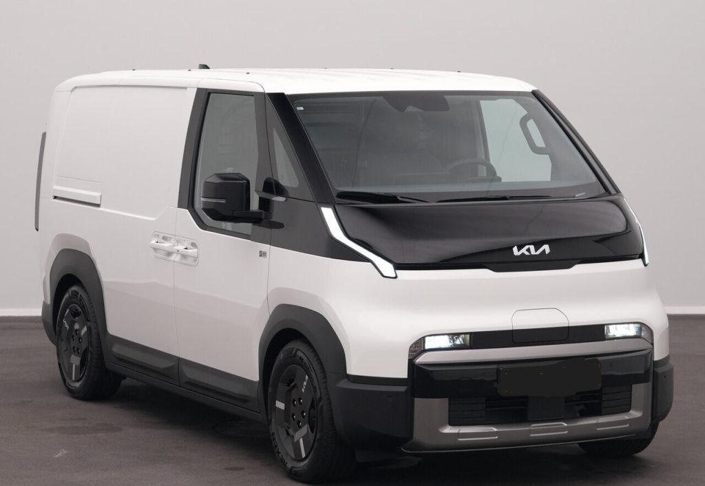 White Kia cargo van shown from the front-left in a studio setting