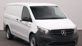 Front-left view of a white Mercedes-Benz cargo van with black bumper and grille in a studio setting
