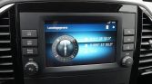 In-dash navigation screen showing a circular compass and location details.