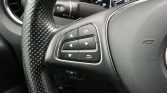 Steering wheel with a four-direction pad and OK button for in-car menus.