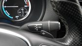 Gear selector stalk near steering wheel showing R N P D positions (automatic transmission).