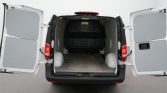 White cargo van with rear doors wide open, exposing an empty cargo area inside