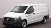 White Mercedes-Benz cargo van photographed in a studio, showing the front and passenger side with a black bumper and mirrors.