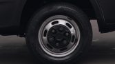 Close-up of a car wheel with a silver rim, five lug nuts, and a Hankook tire on pavement.