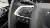 Close-up of steering wheel controls: directional pad around an OK button, with phone and menu buttons below