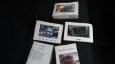 Collection of Iveco vehicle manuals and booklets spread on a dark car seat, including a maintenance register in French.