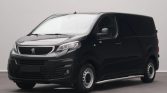 Black Peugeot panel van, front-left three-quarter view in a studio setting.