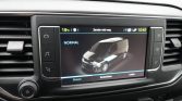 Car infotainment screen showing a 3D van graphic with 'NORMAL' status on a car dashboard.