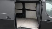 Open cargo van with empty load area; dark exterior and light interior panels, side door swung open revealing bare floor and walls