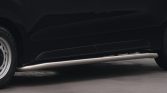 Side view of a black van showing a silver running board along the bottom edge of the door area