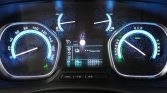 Blue-lit car instrument cluster: left circular speedometer up to 180 km/h, center digital display, right power/charge gauge with 'READY' indicator; odometer reads 58,996 km.