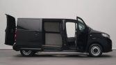 Black cargo van with both side and rear doors open, showing an empty cargo area in a studio setting.
