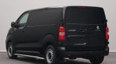 Rear three-quarter view of a black Peugeot e-Expert van in a studio setting, showing the cargo doors and taillights.